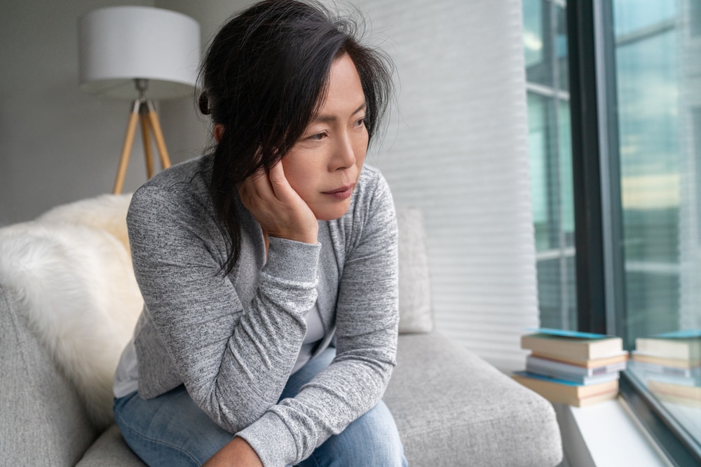 Mature woman looking sad while experience mood swings during menopause