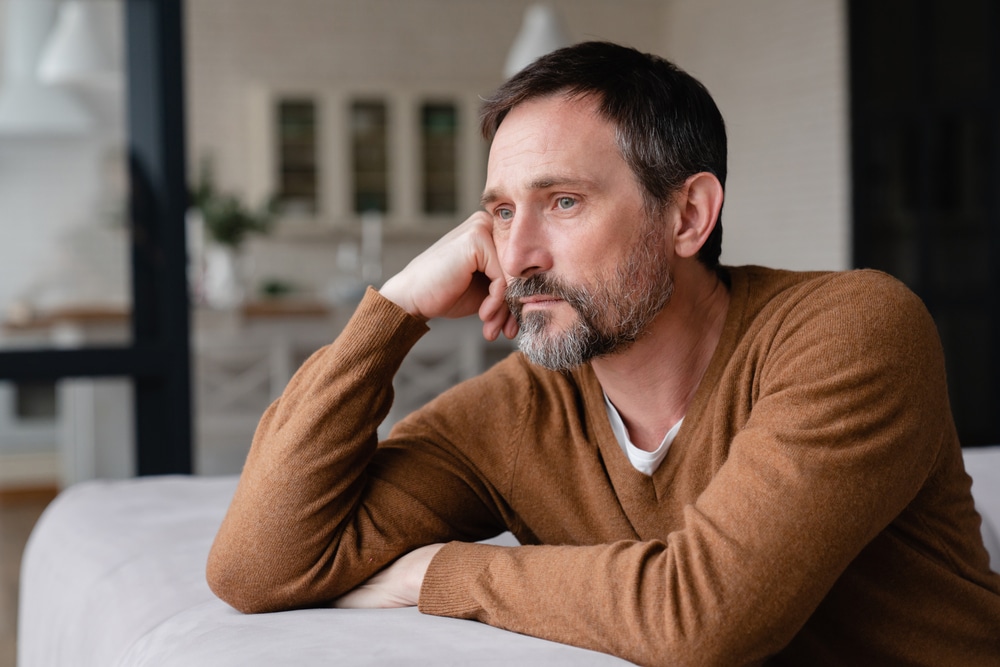 Mature man looking tired and depressed due to low testosterone.