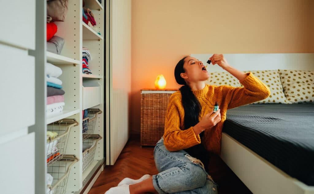 Millennial at home using CBD oil for anxiety