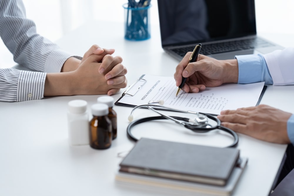 A close-up shot of a concierge doctor's hands while talking to a patient