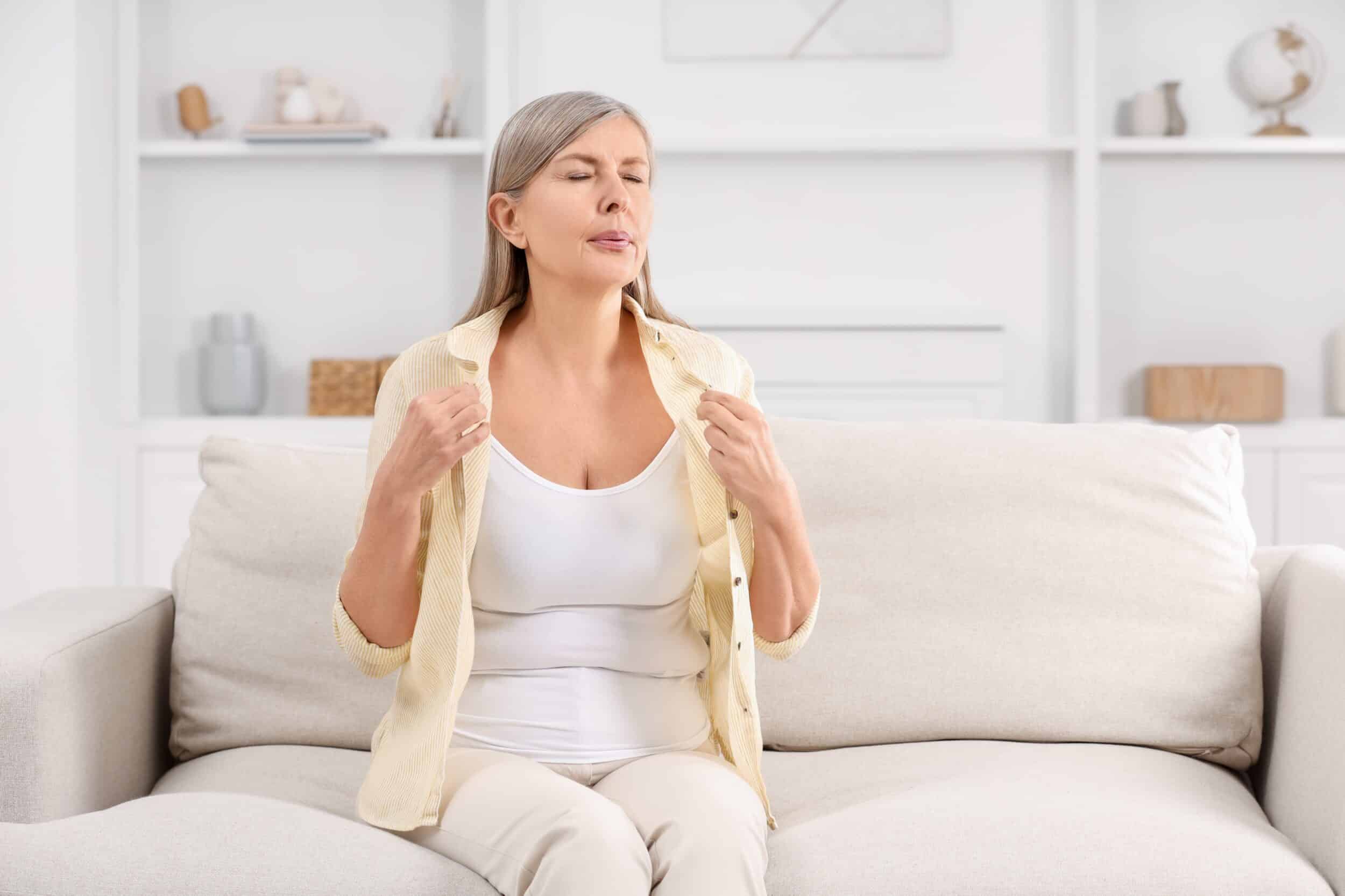 Woman experiencing menopause symptoms in Naples