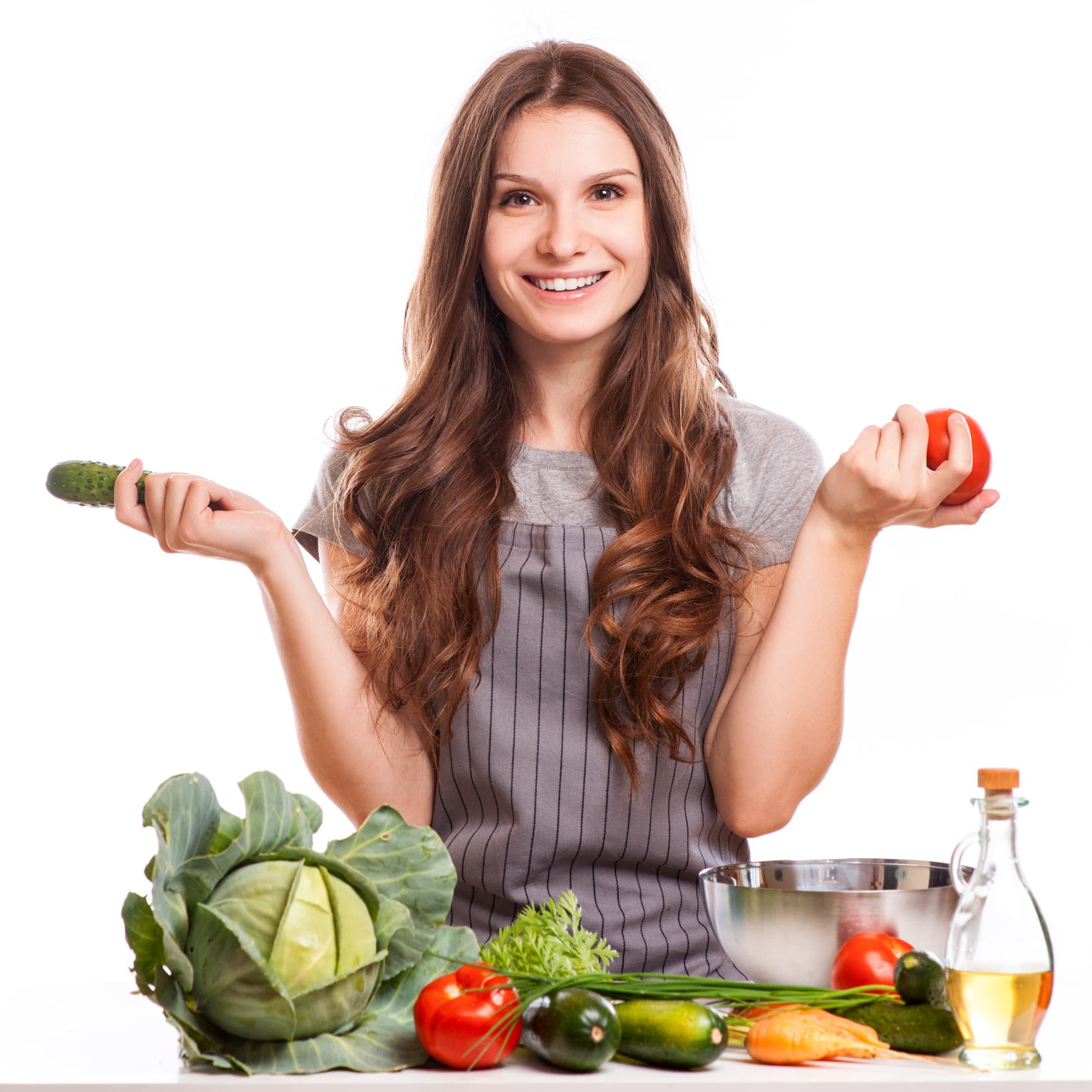 Woman making a salad in her kitchen to support her weight loss journey.