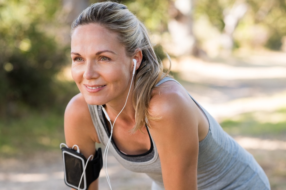 Woman exercising outdoors, representing strength and healthy aging during menopause.
