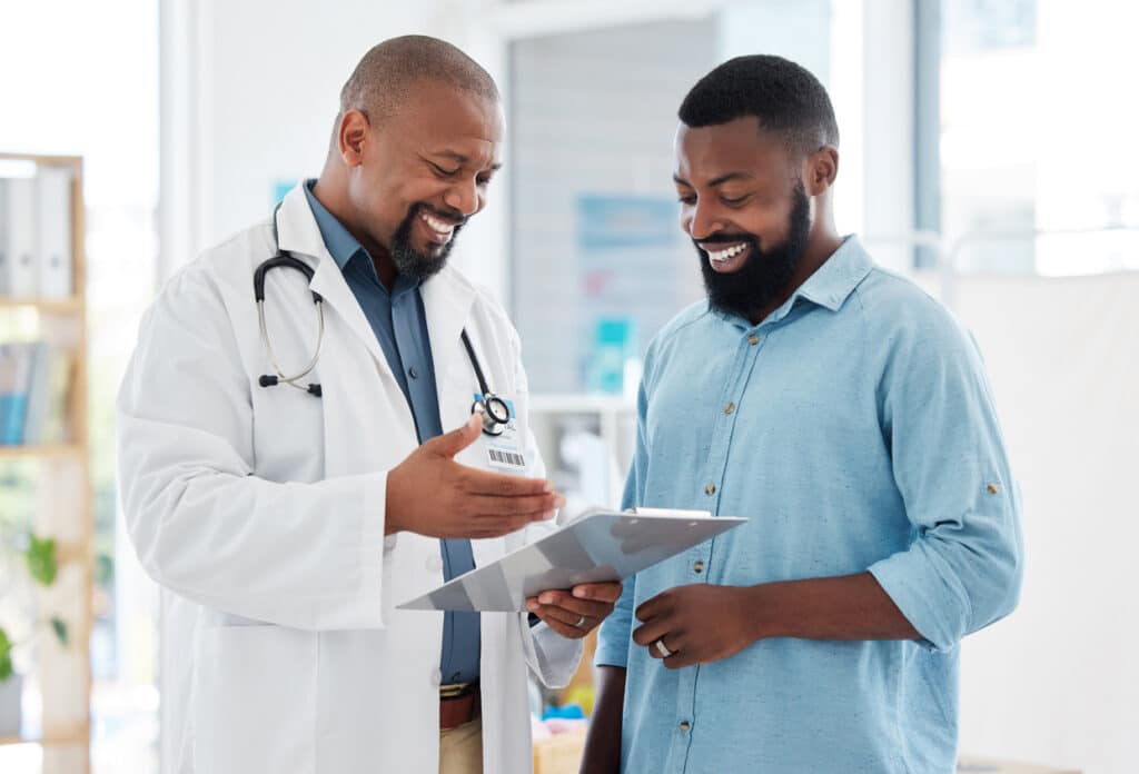 Male patient reviewing testosterone test results with a physician during a hormone health consultation.