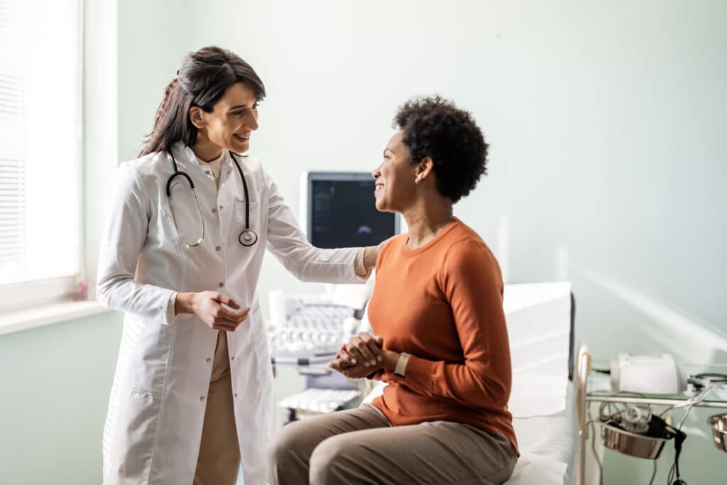 Female physician speaking with a patient during a body composition and weight management consultation.