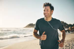 Man jogging outdoors to support strength and bone health as he ages